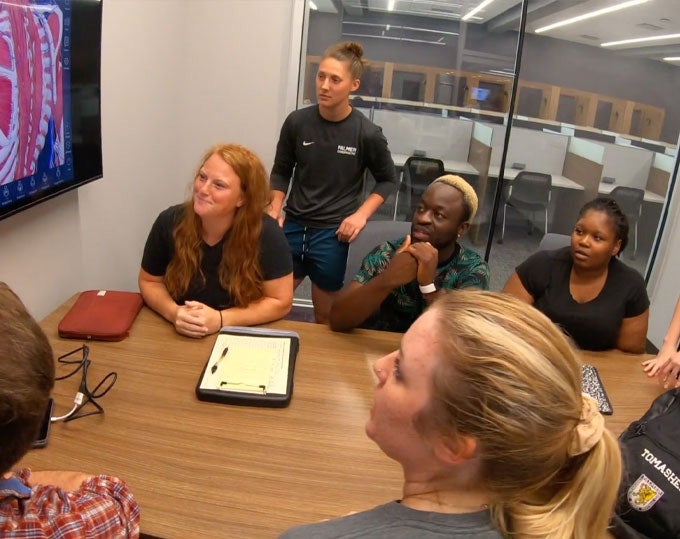 Group studying together in Library room.