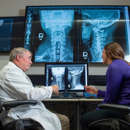 Dr. McLean discussing X-rays with student.