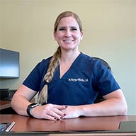 Morgan Miholics in blue clinic scrubs