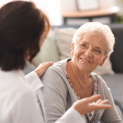 Clinician speaking to older patient.