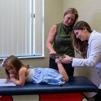 Clinician working with pediatric patient.