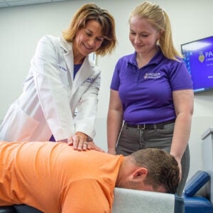Dr. Klaus adjusting patient's back.