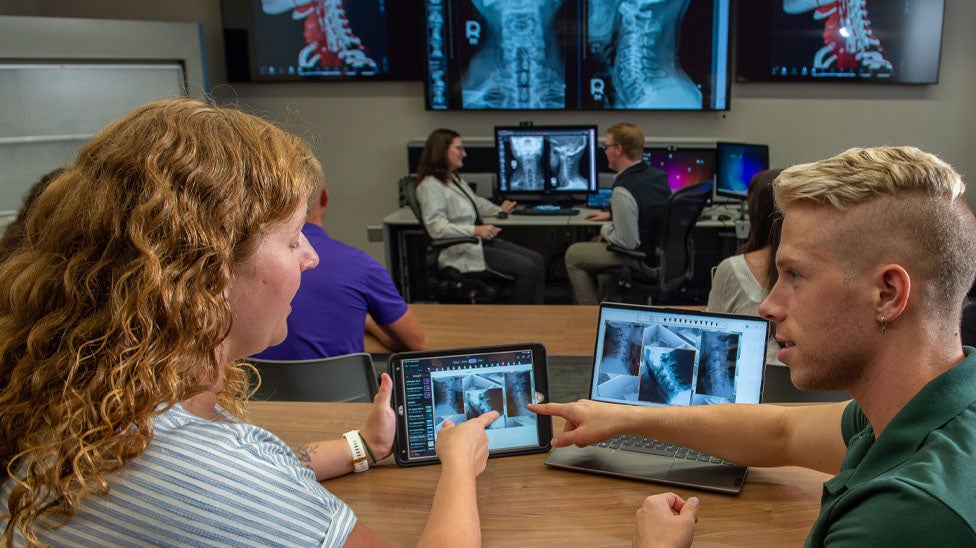 Students reviewing X-rays on iPad.