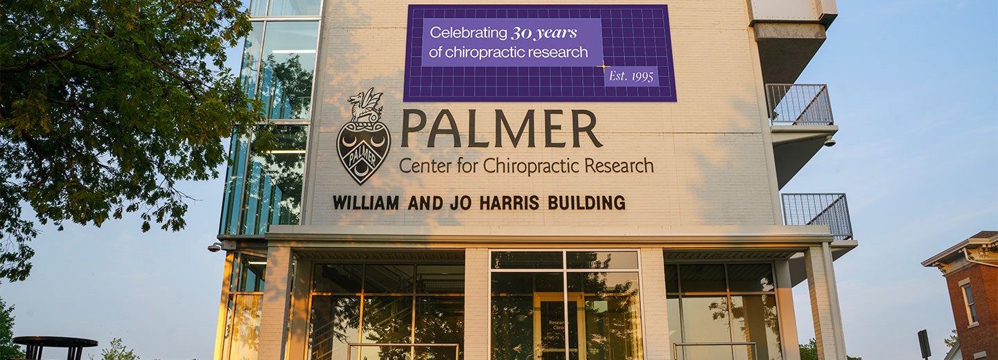 Palmer Center for Chiropractic's William and Jo Harris Building with 30 year anniversary banner.