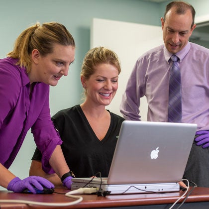 Research employees reviewing results on computer.