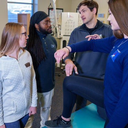 Rehab Clinician working with students.