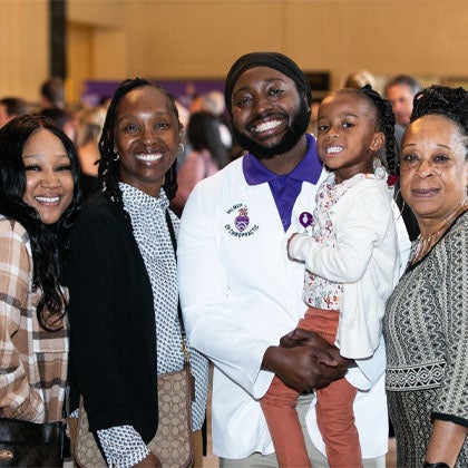 Graduate with family after graduation.