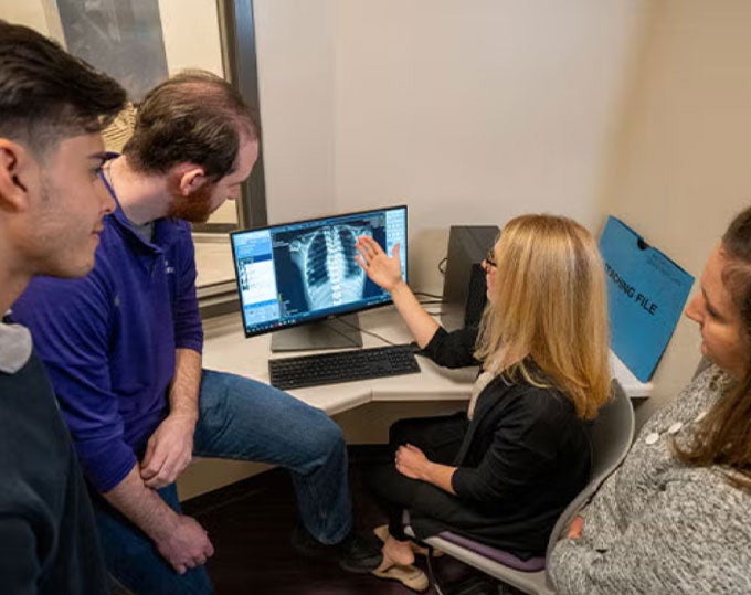 Group reviewing X-ray.