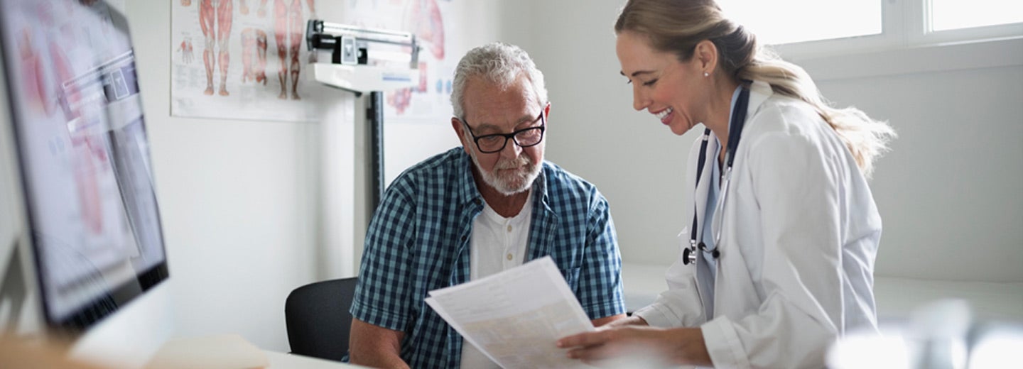 Doctor speaking with patient in exam room.