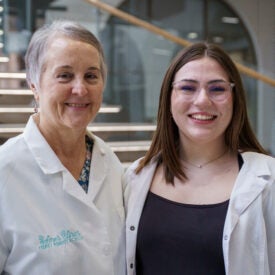 Meghan Erickson and Dr. Cherie L. Marriott in white coats.