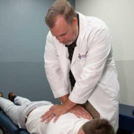 Dr. Bryan Asby adjusting a patient.