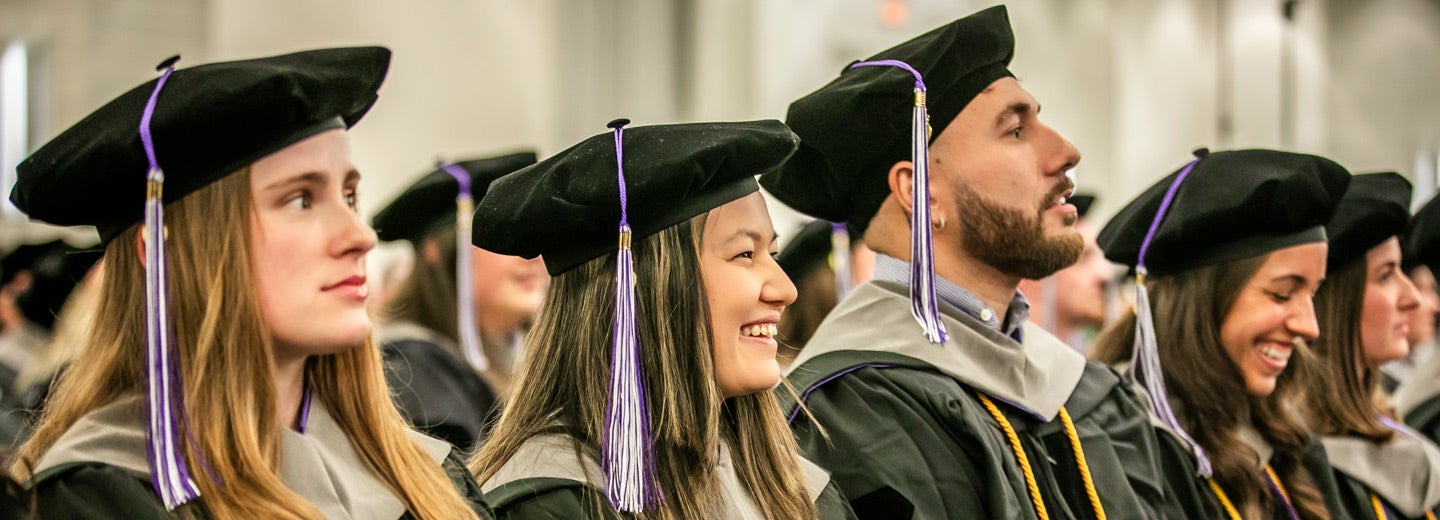 Palmer Florida class 261 in graduation caps and gowns listening to speaker at commencement.