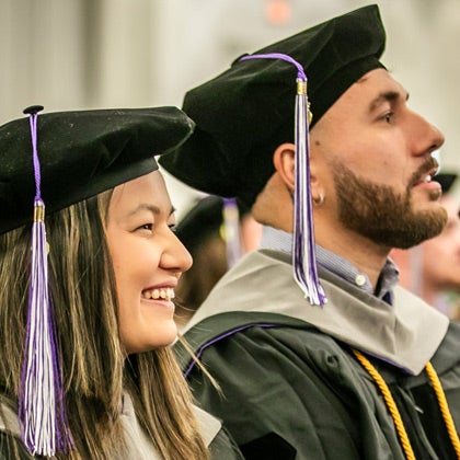 Palmer Florida class 261 in graduation caps and gowns listening to speaker at commencement.