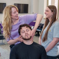 Dr. Hynes teaching technique to Palmer student.