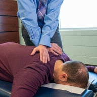 Dr. Vining, research professor, adjusting a patient.